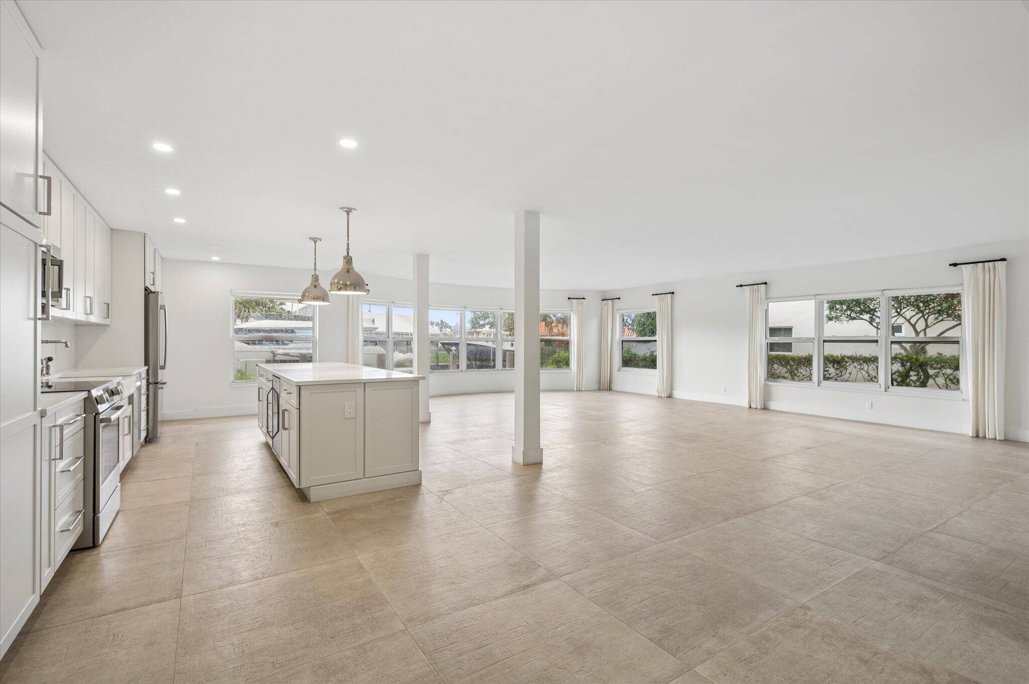 Image 1: Generous open-concept layout with panoramic water