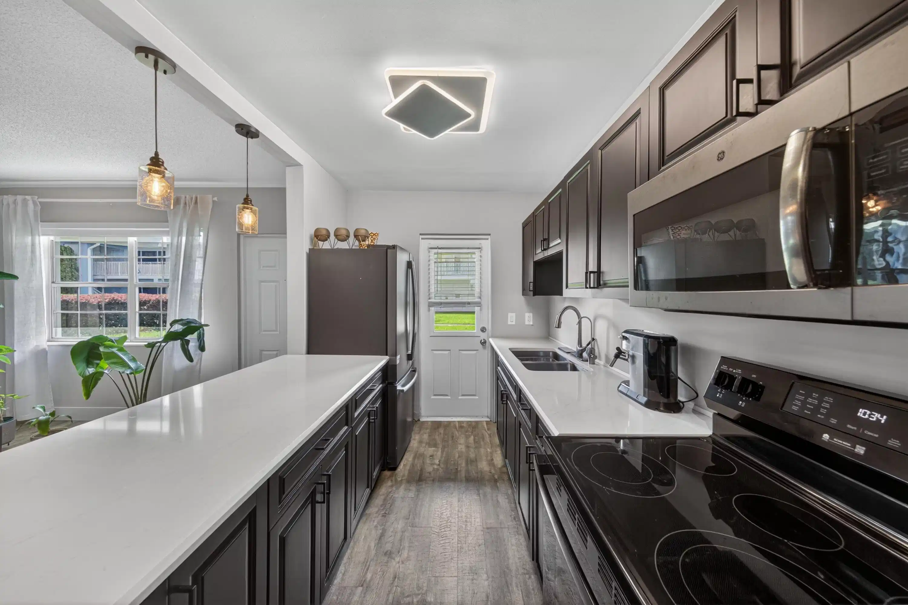 Image 1: Large Galley Kitchen - Espresso cabinets and Quart