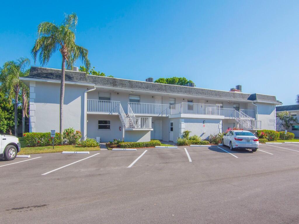 Image 2: Multi-story building featuring stucco exterior, mu