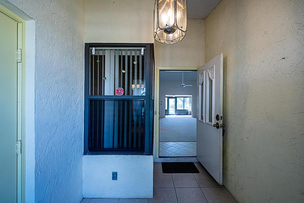 Image 2: Entryway, front door, and garage door