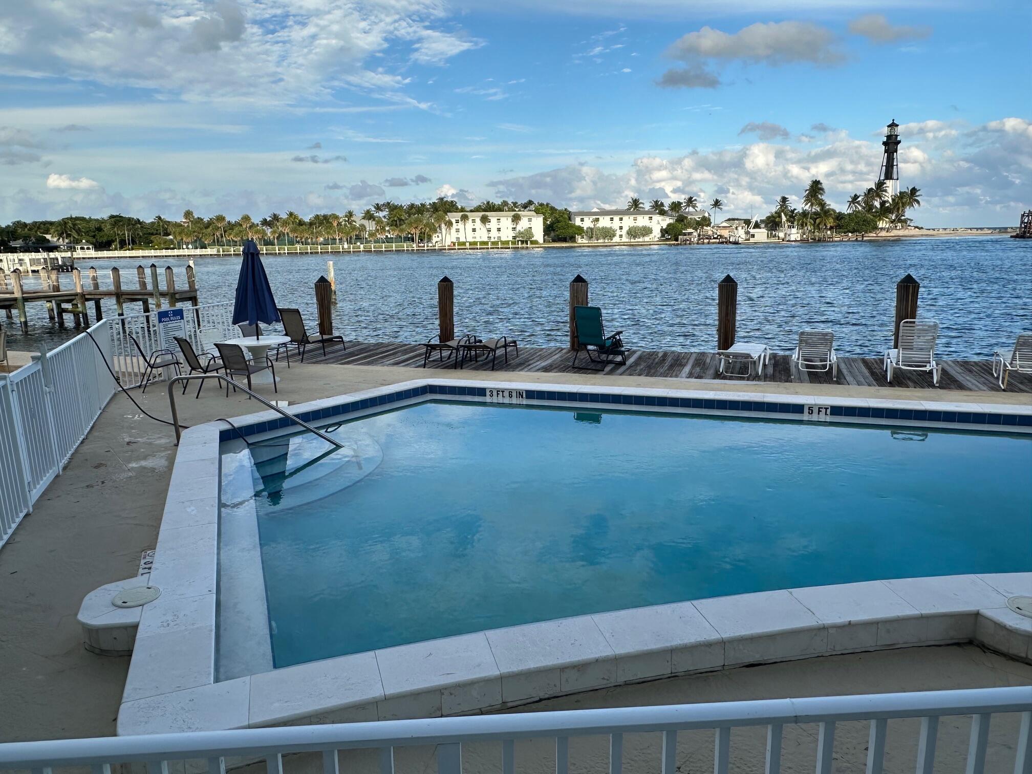 Image 4: Relax and unwind in the waterfront pool overlookin