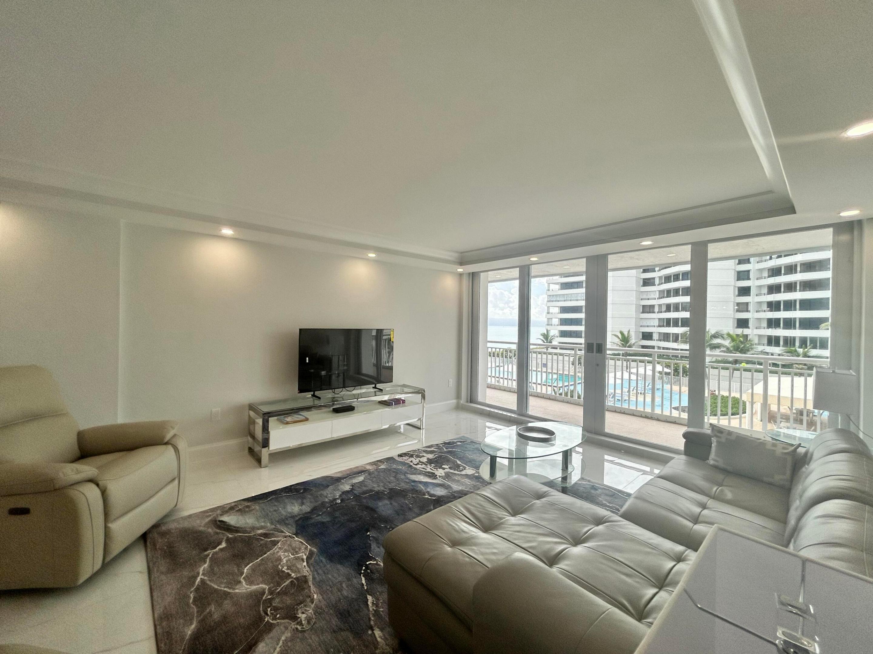 Image 4: Living area with tile flooring and recessed lighti