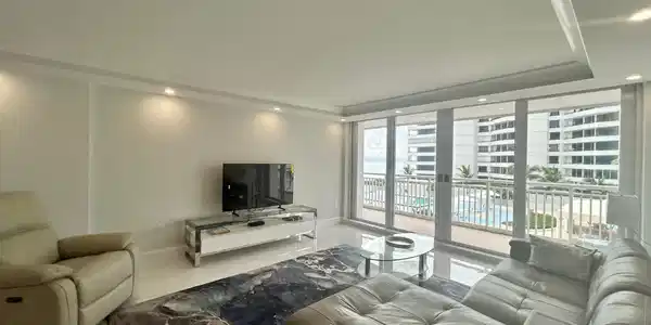 Image 4: Living area with tile flooring and recessed lighti