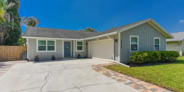 Image 4: Single-story residence featuring light gray siding
