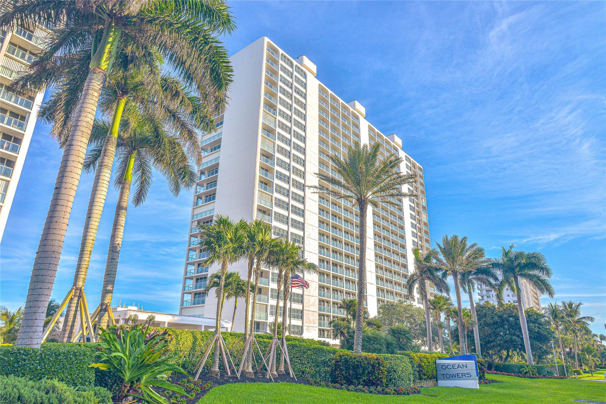 Image 3: High-rise building with multiple balconies, surrou