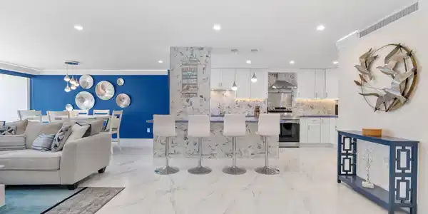Image 4: Open-concept living space featuring large format t