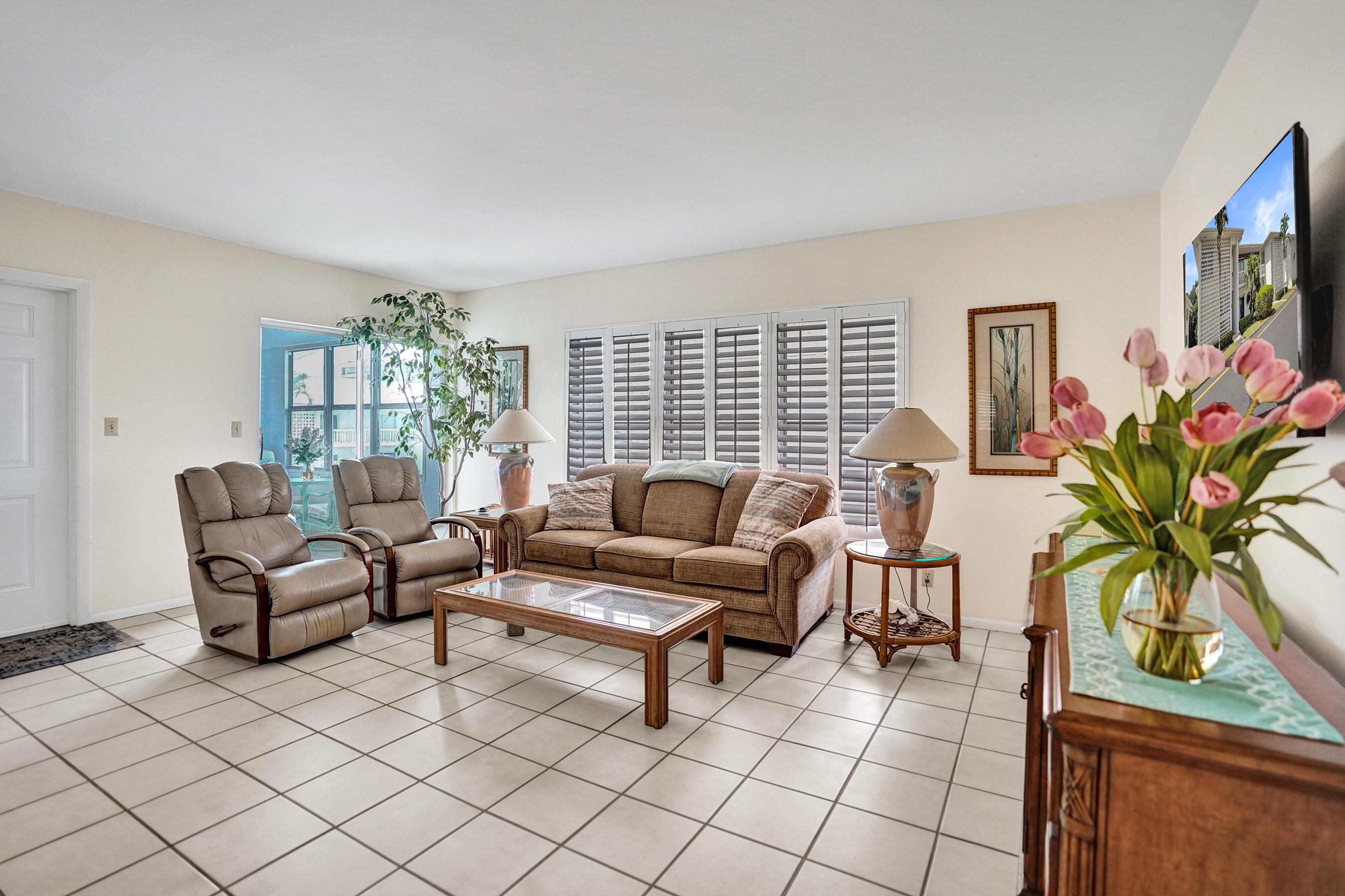 Image 2: Spacious common area featuring light-toned tile fl