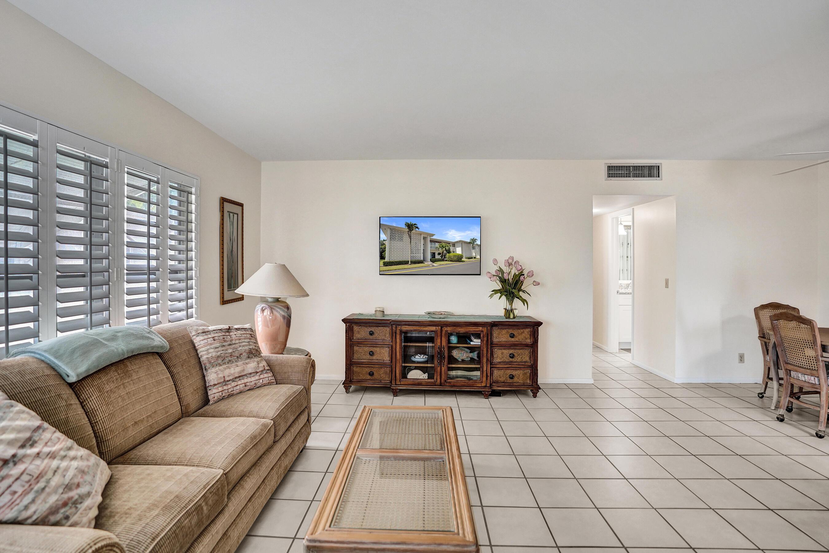 Image 4: Large living area featuring white tile flooring, p