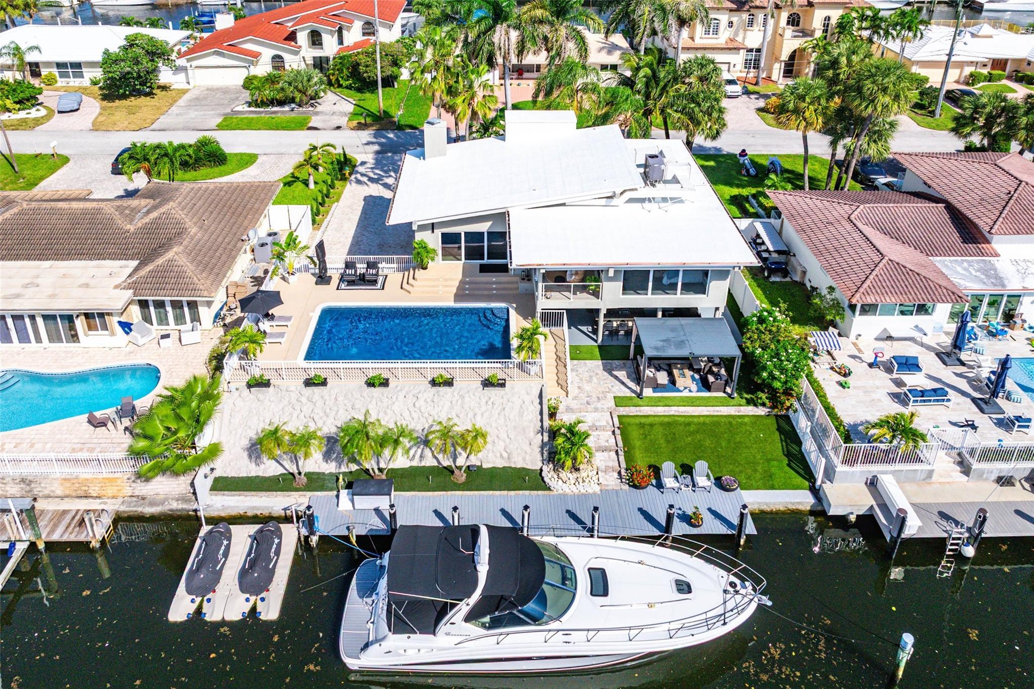 Image 1: Hero aerial, full property with pool, dock and boa