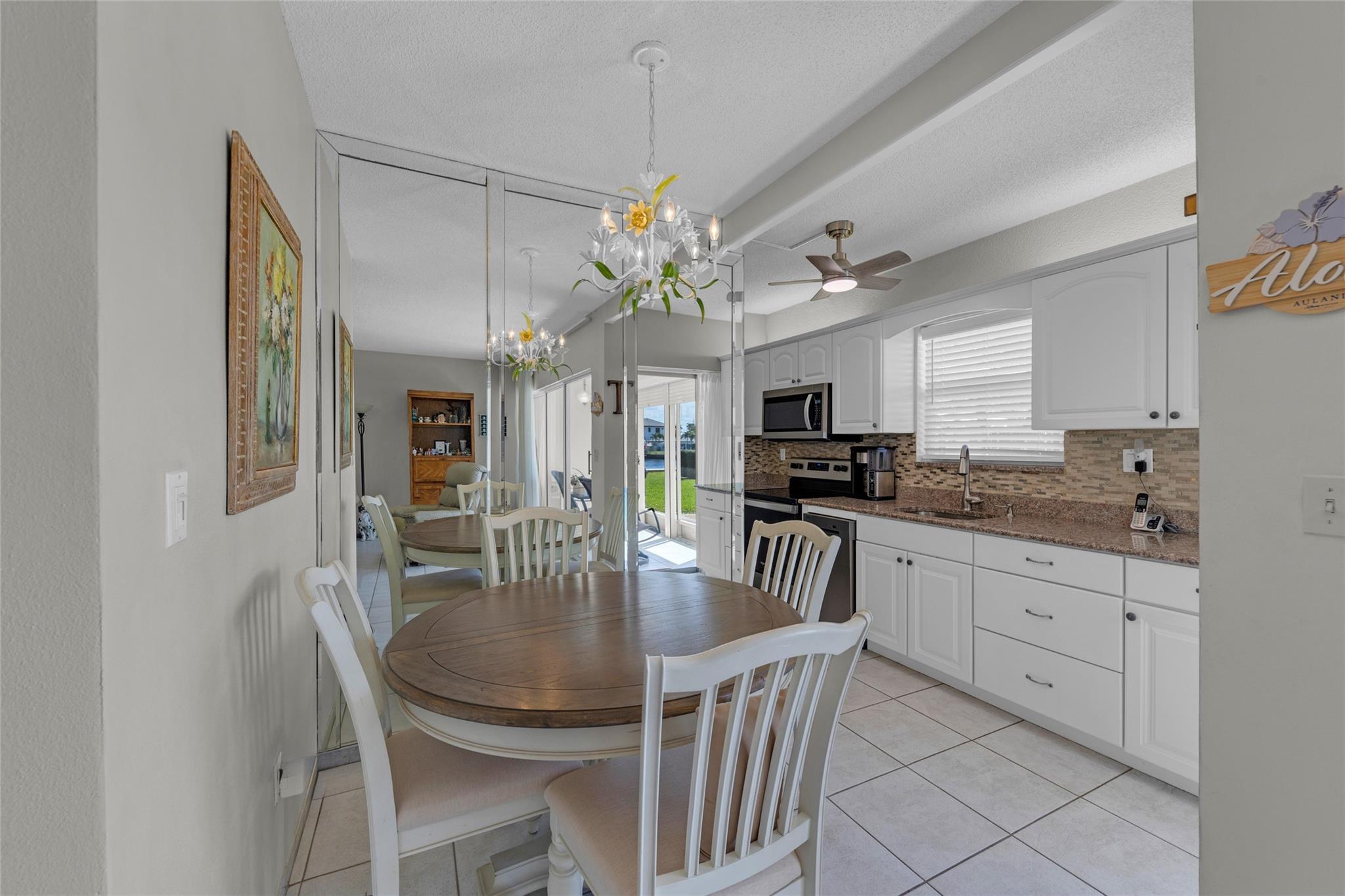 Image 2: Dining and kitchen with tile flooring and an abund