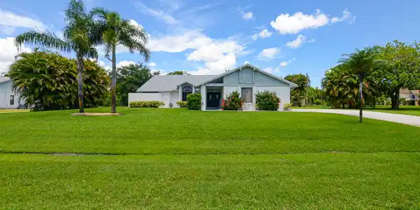 Image 3: Spacious front yard with a lush lawn, established
