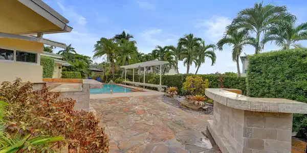 Image 3: Outdoor space featuring a swimming pool, flagstone