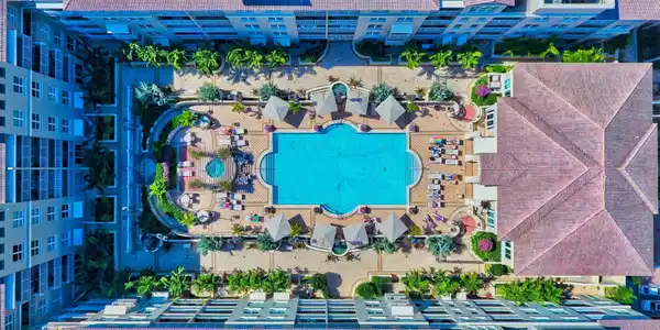Image 4: Resort-style courtyard featuring a large swimming