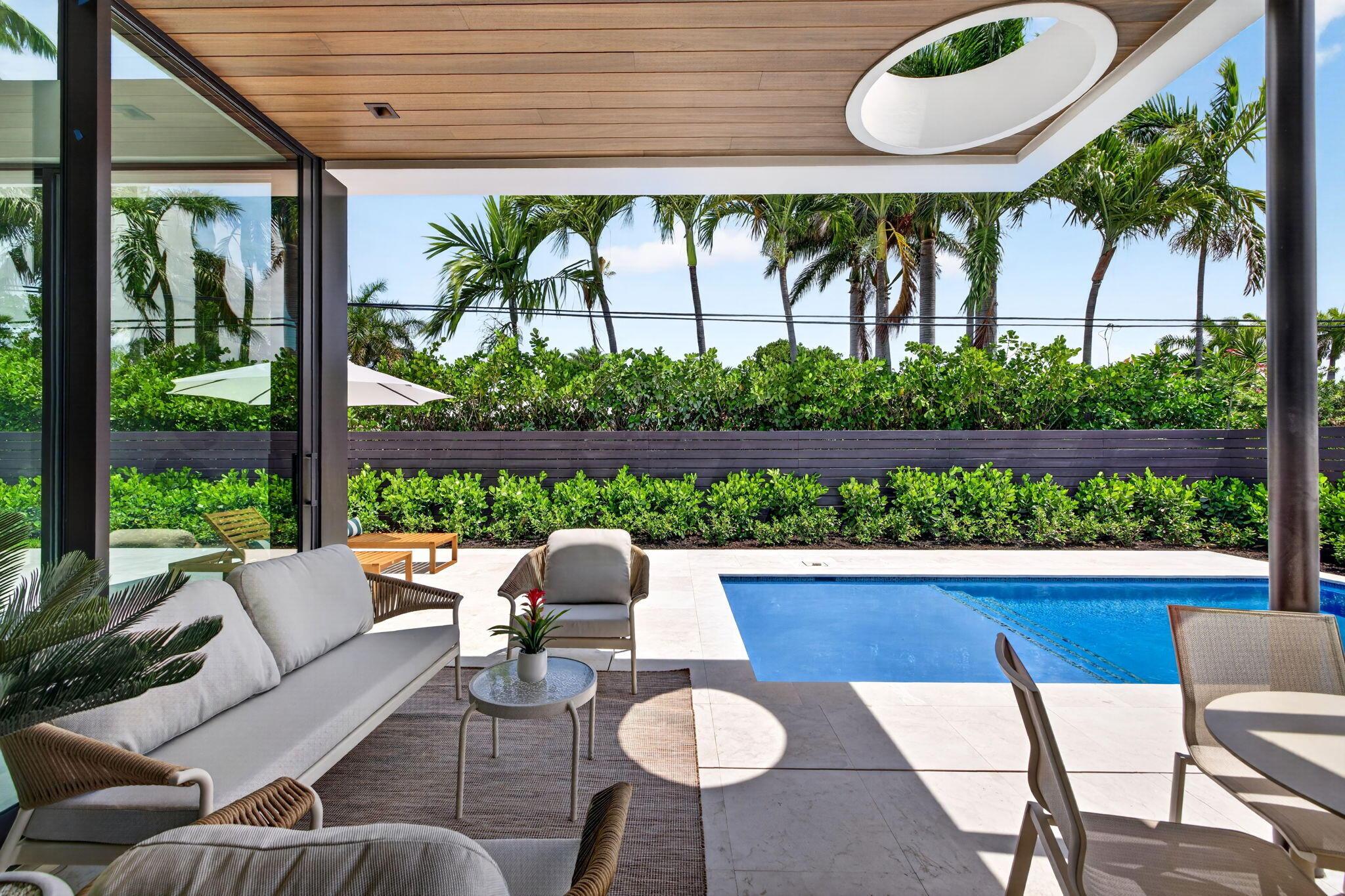 Image 2: A resort-style patio setting connects the interior