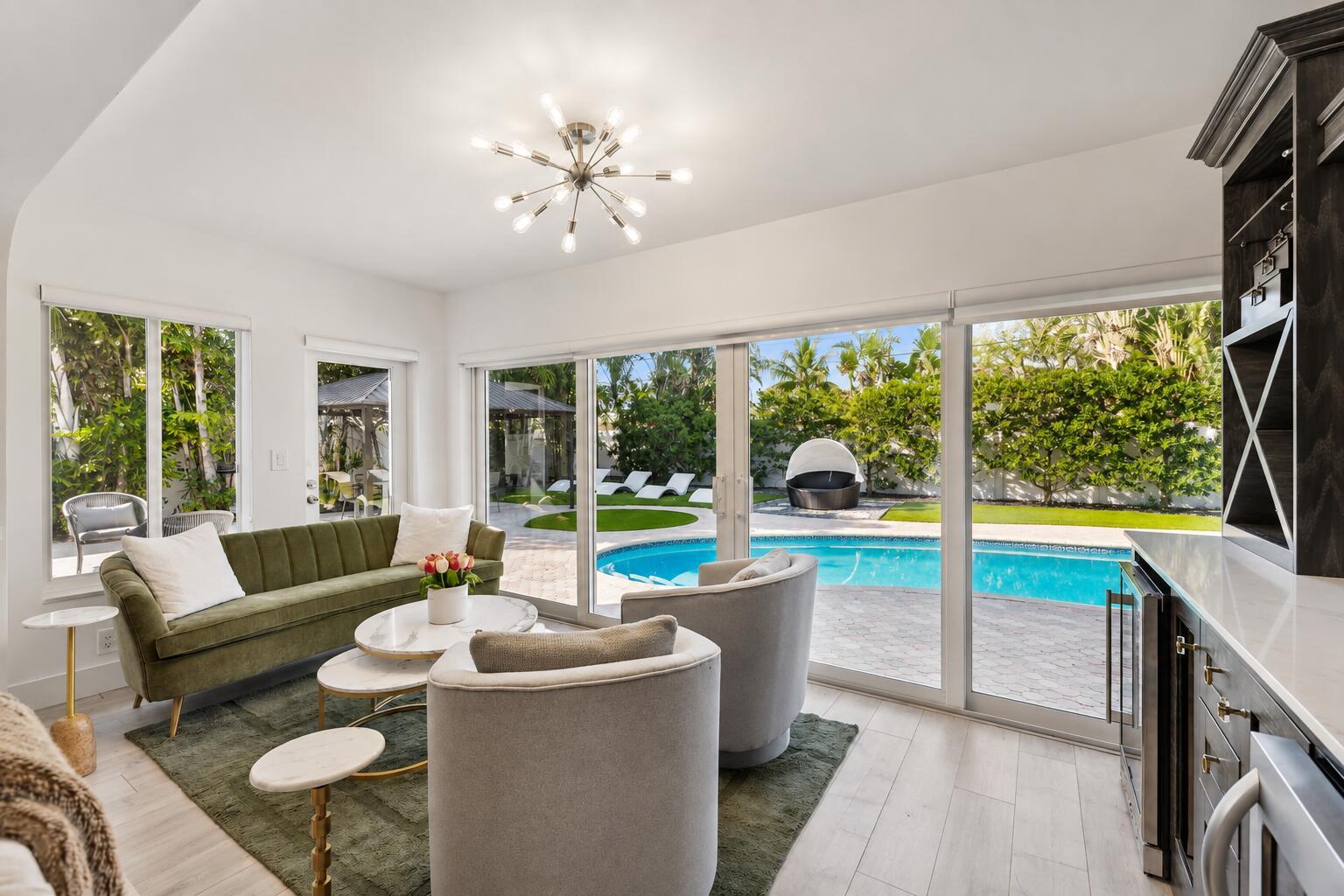 Image 3: Sophisticated poolside living space featuring expa