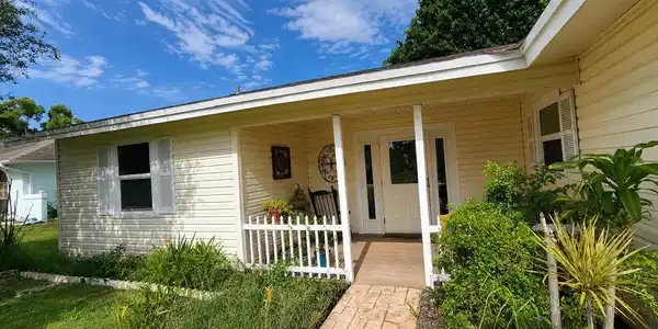 Image 3: Front exterior featuring horizontal siding and a c