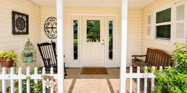 Image 4: Welcoming front entry featuring a white door with