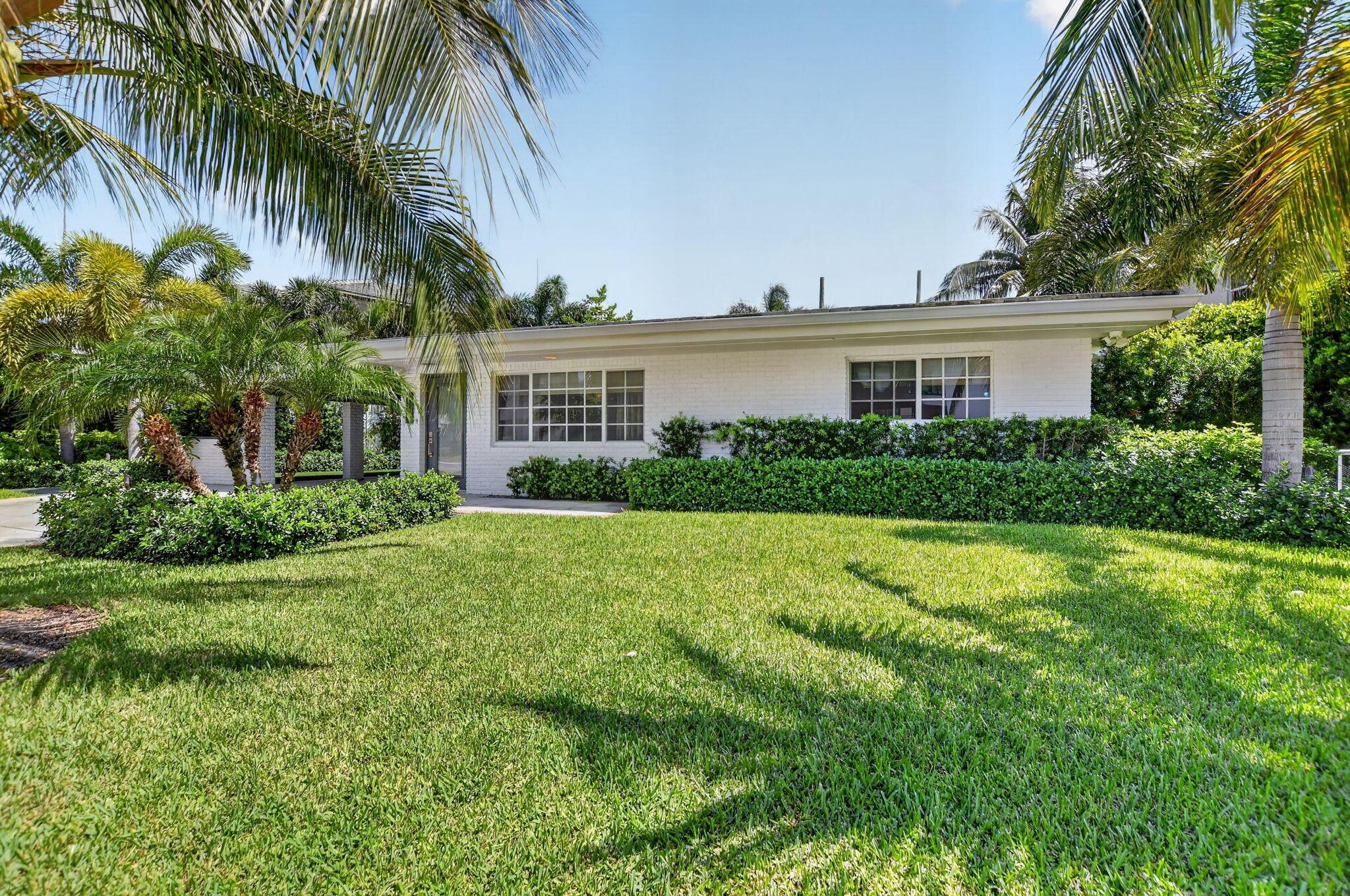 Image 3: This Florida home offers many swaying palm trees t