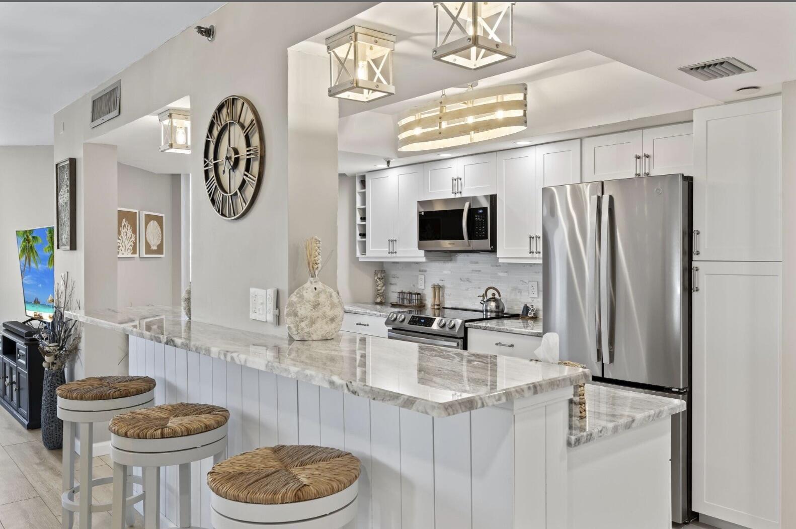 Image 3: Custom breakfast bar opens to dining/living area.