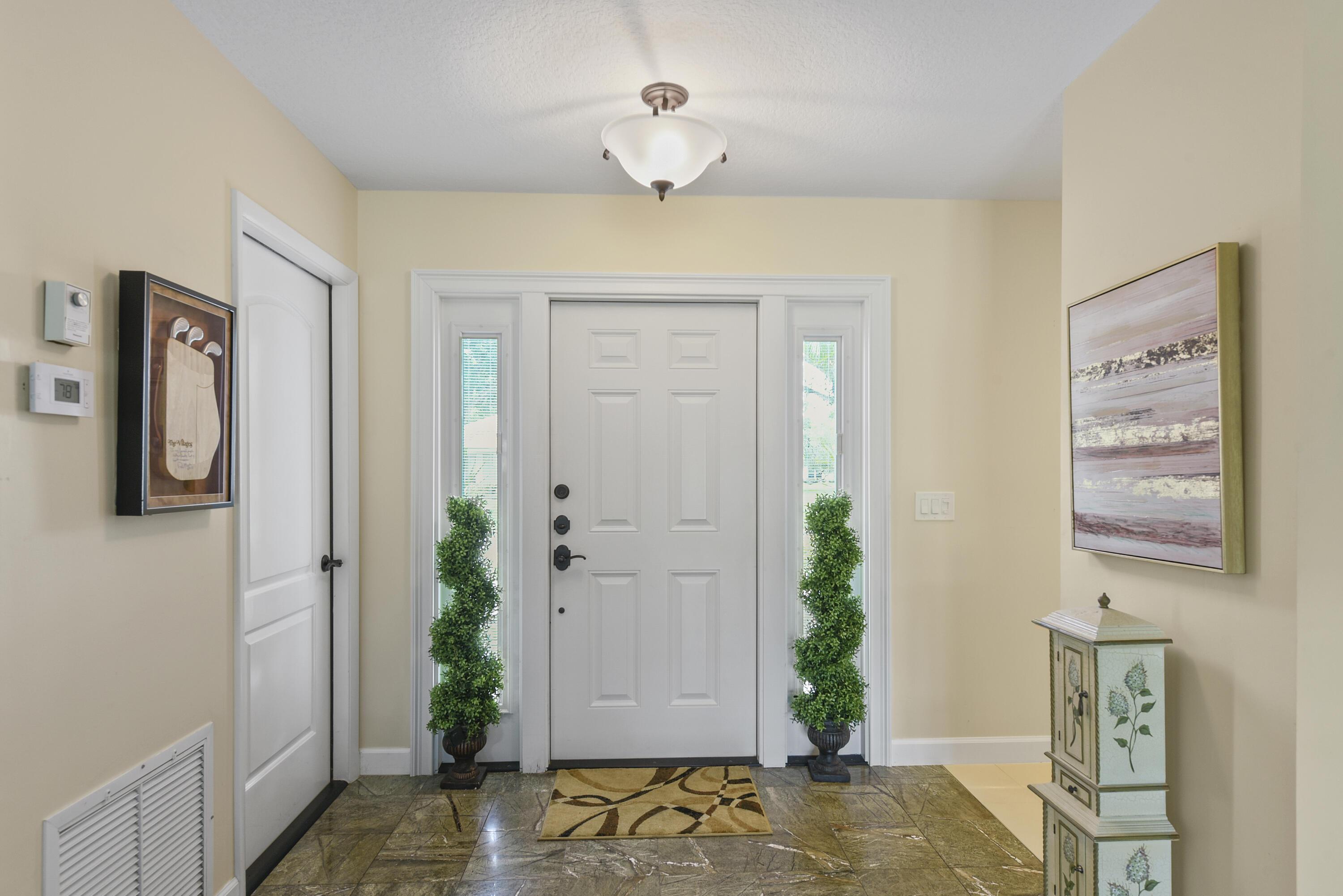 Image 2: Entryway featuring a paneled door with sidelight w