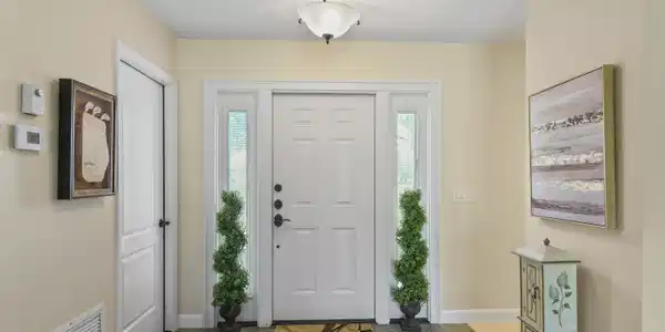 Image 2: Entryway featuring a paneled door with sidelight w