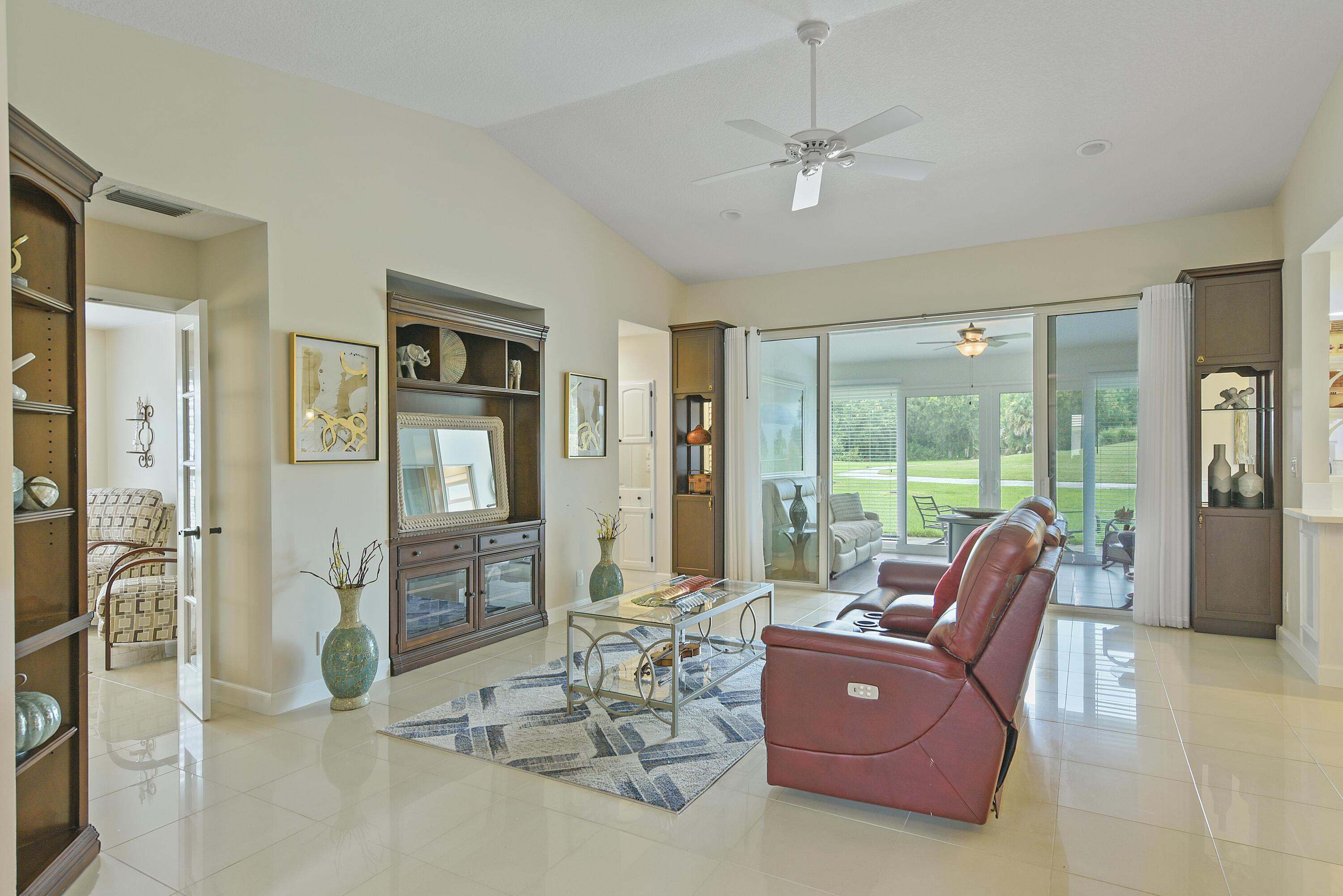 Image 3: Spacious living area featuring polished tile floor