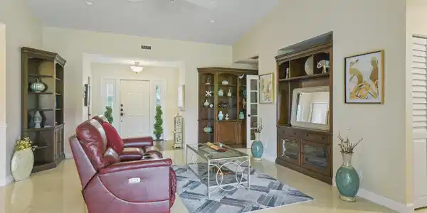 Image 4: Living area with light-toned tile flooring and vau