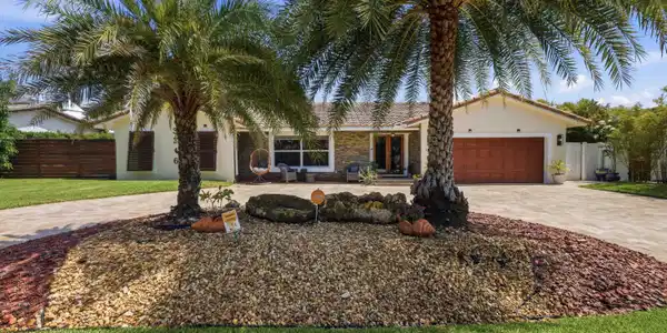 Image 4: Front exterior featuring a circular driveway, matu