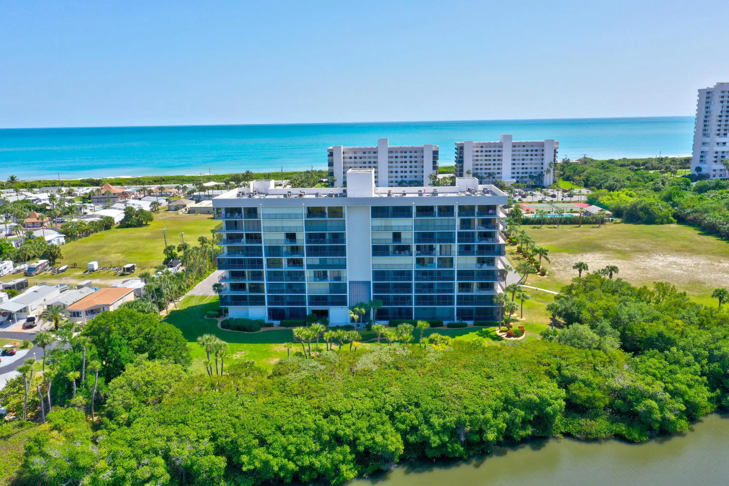 Image 1: Multi-story condominium building featuring extensi