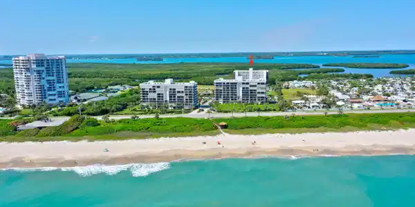 Image 4: Expansive beachfront with clear waters and a sandy