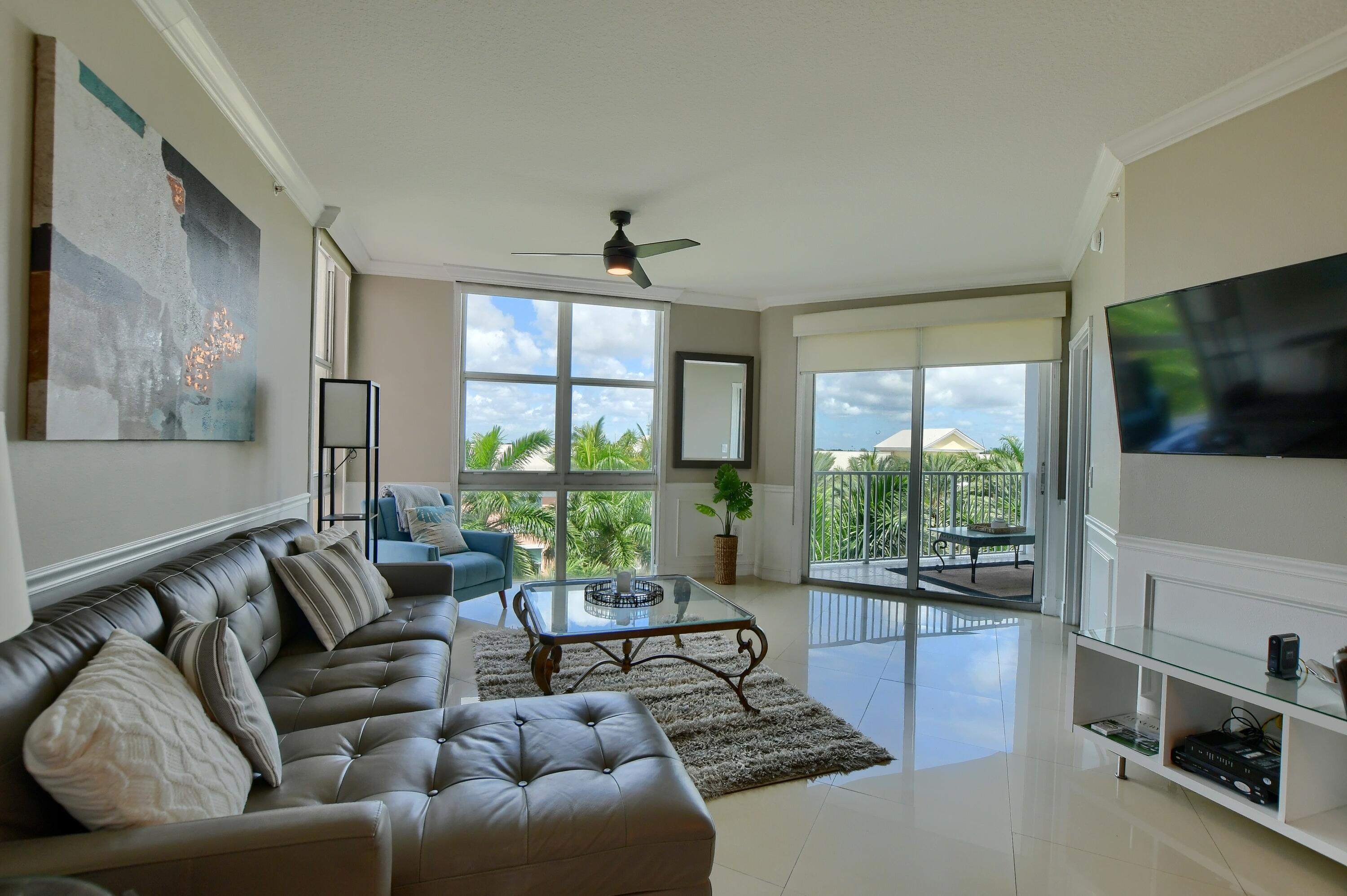Image 2: Spacious living area featuring large windows, crow