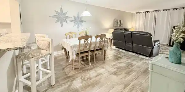 Image 4: Bar seating, formal dining, open concept living.
