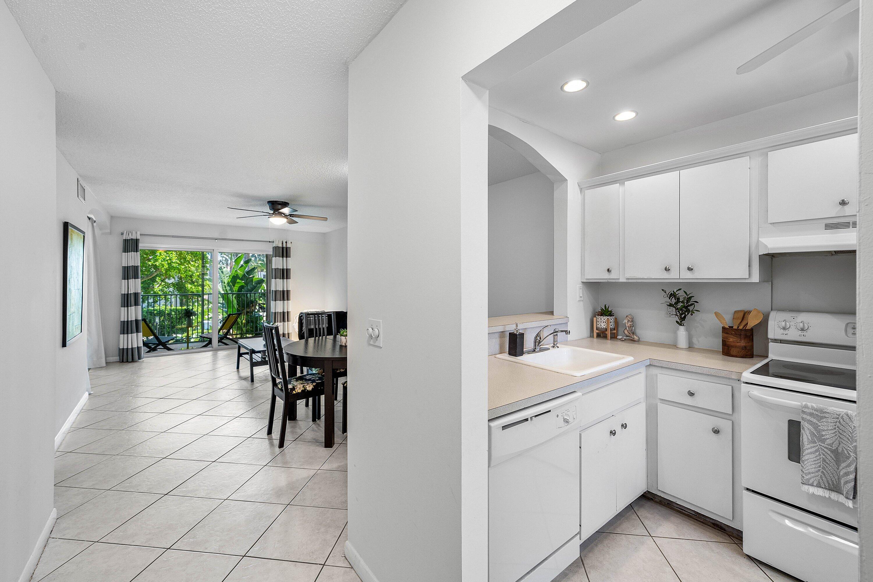 Image 2: White cabinetry in the kitchen with a built-in dis