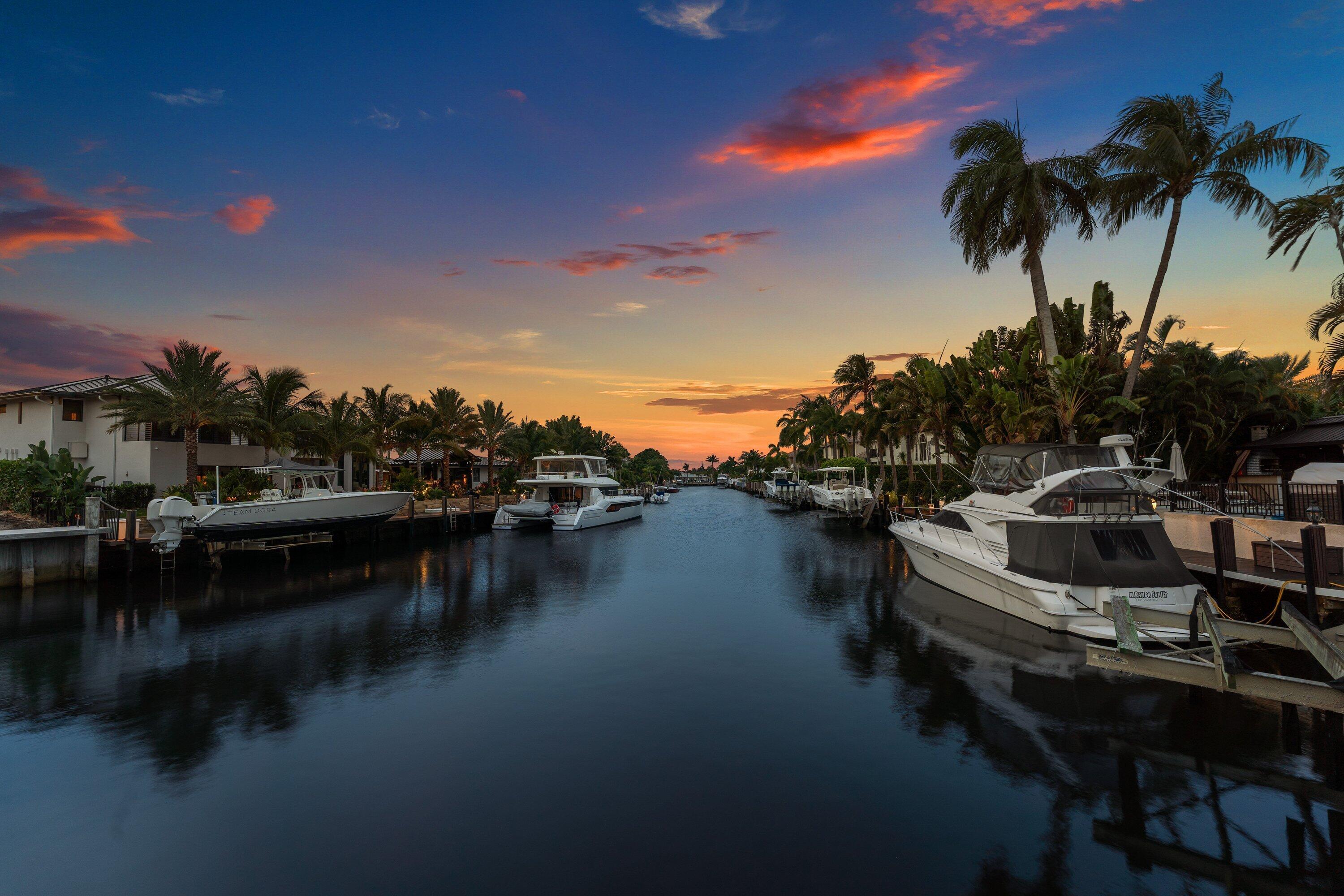 Image 1: Waterfront canal featuring private docks and matur