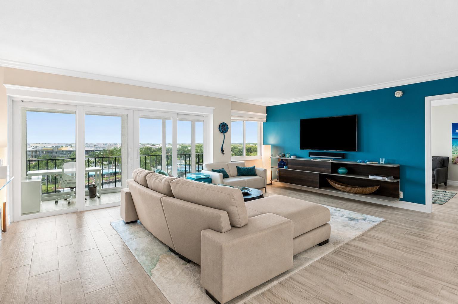 Image 4: Living room has sliders to a glass enclosed balcon