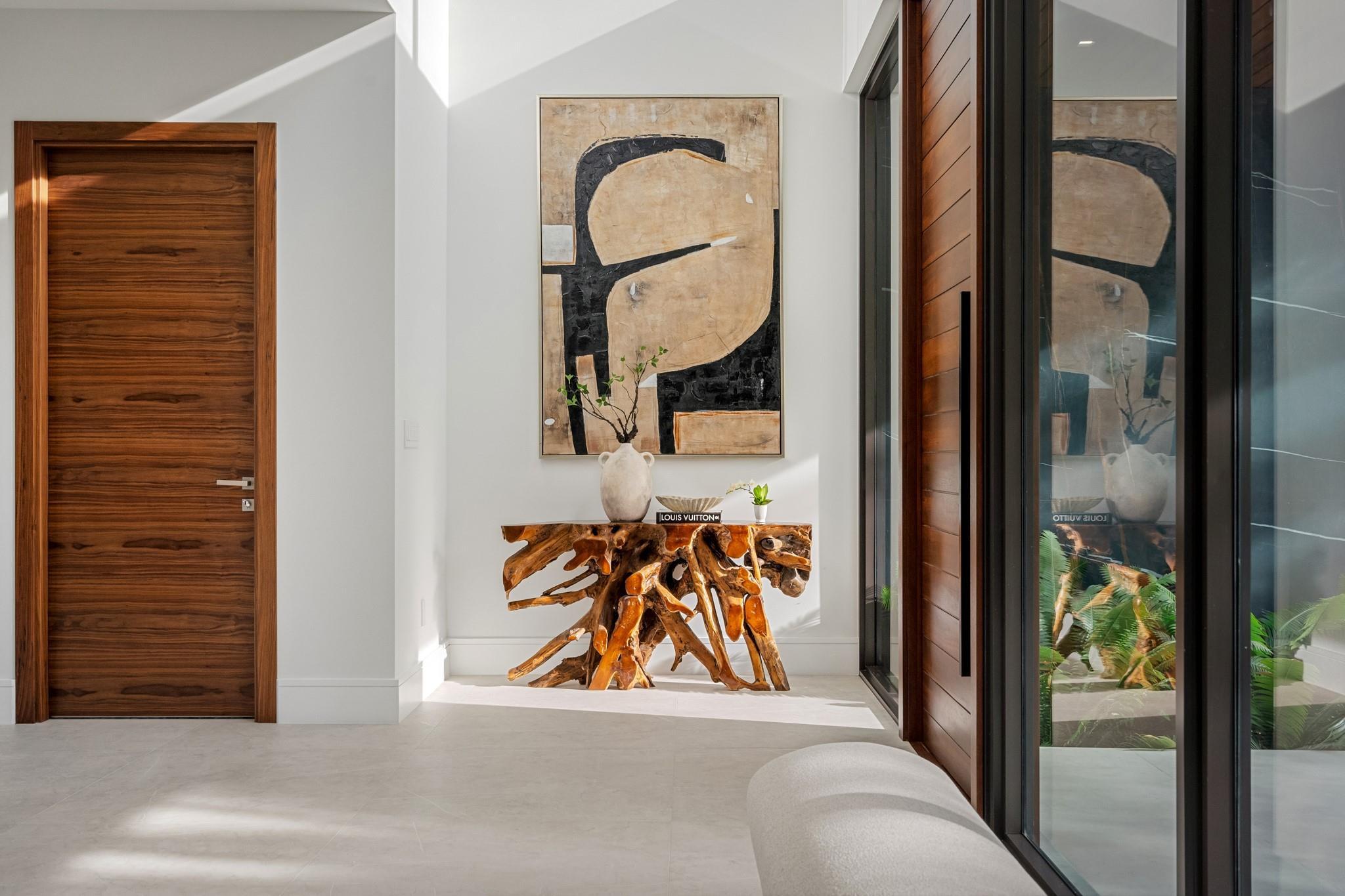 Image 2: A refined entry vignette showcasing a rich wood fr