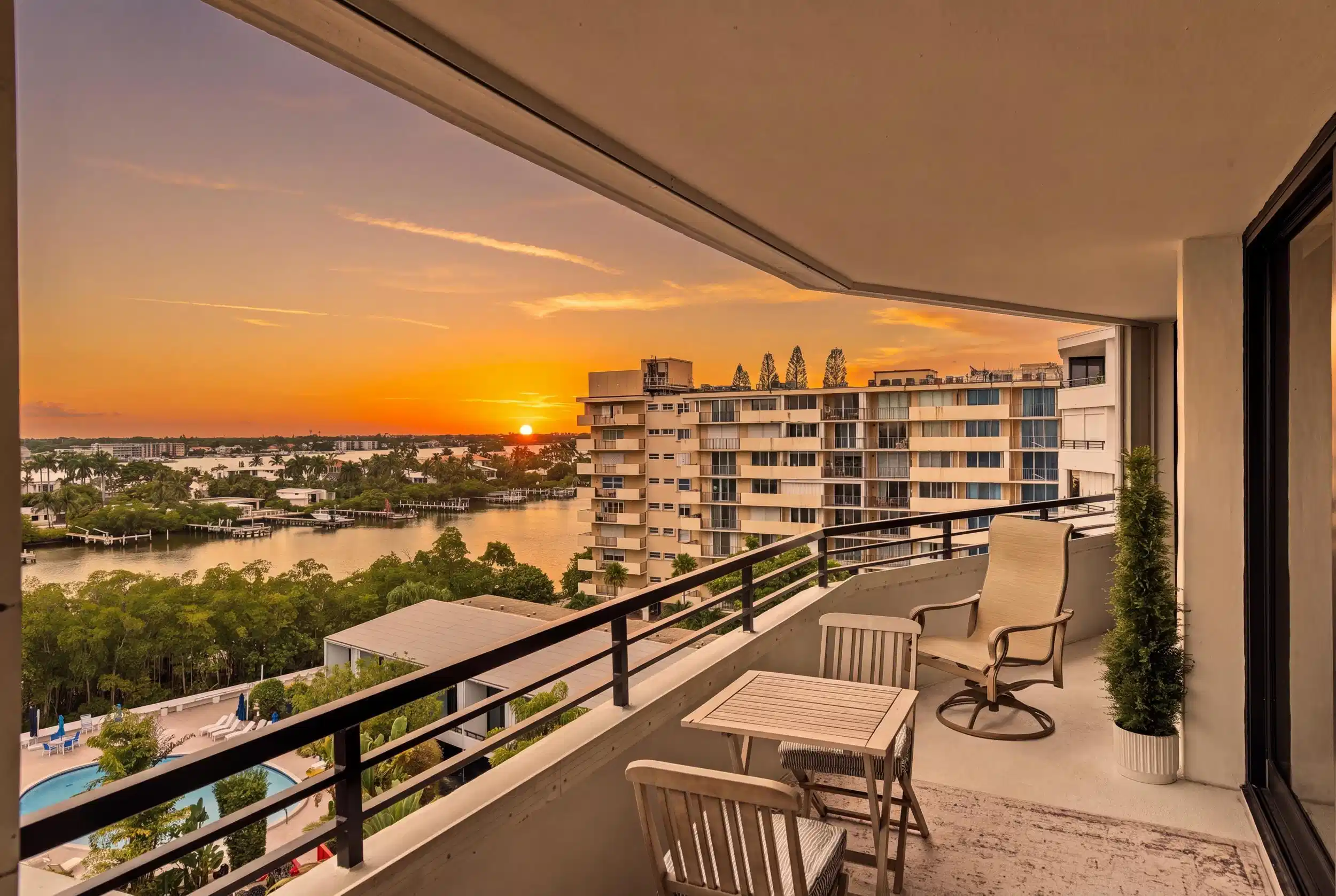 Image 1: Expansive private balcony with a water backdrop