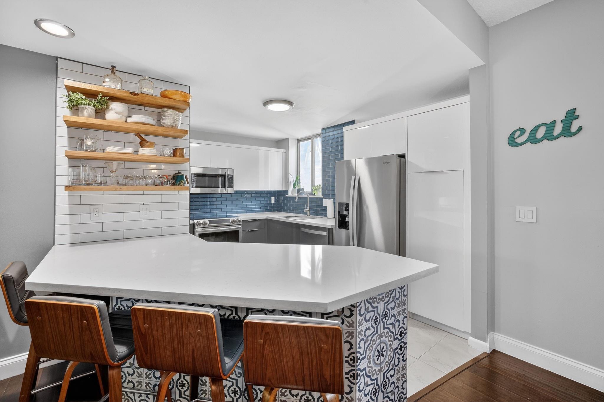 Image 4: The updated kitchen offers quarts countertops with