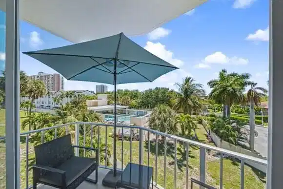 Image 1: Overed balcony with pool view