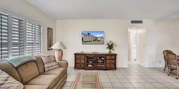 Image 4: Large living area featuring white tile flooring, p