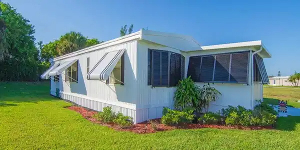 Image 2: White exterior siding with dark shutters