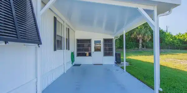 Image 3: Covered patio with a light gray concrete surface