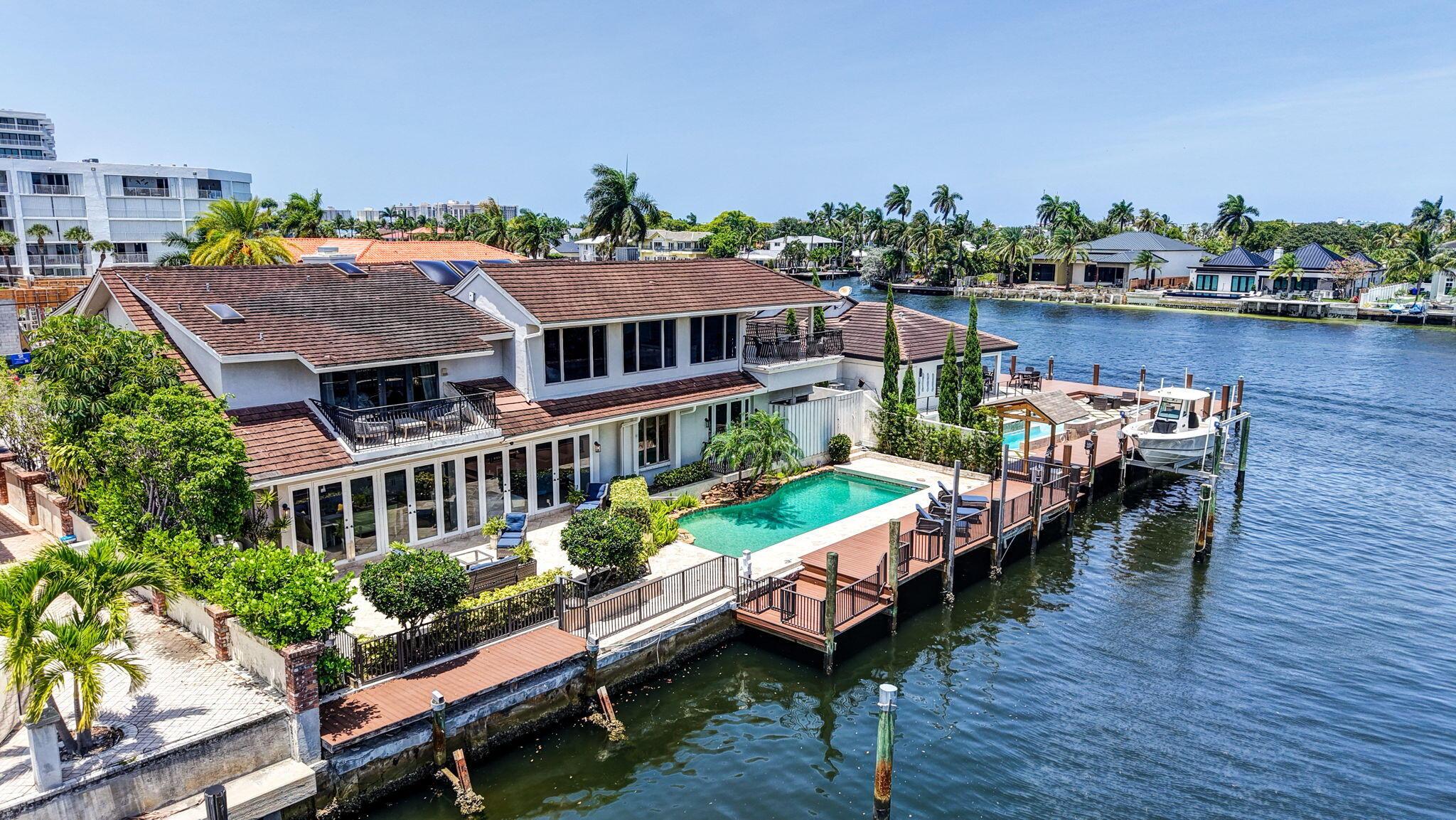 Image 1: This aerial view shows the home&rsquo;s rear elevation,