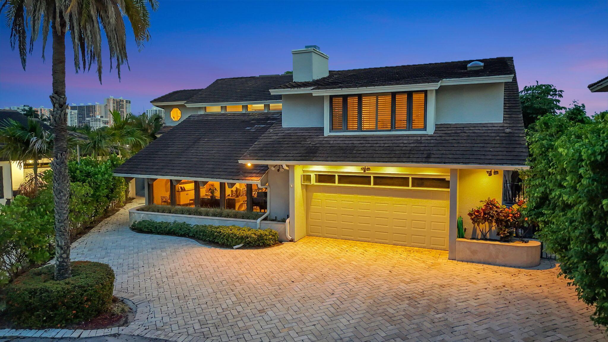 Image 3: Elegant twilight curb appeal introduces the reside