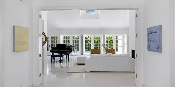 Image 4: Foyer leading to living room with a solid wall of