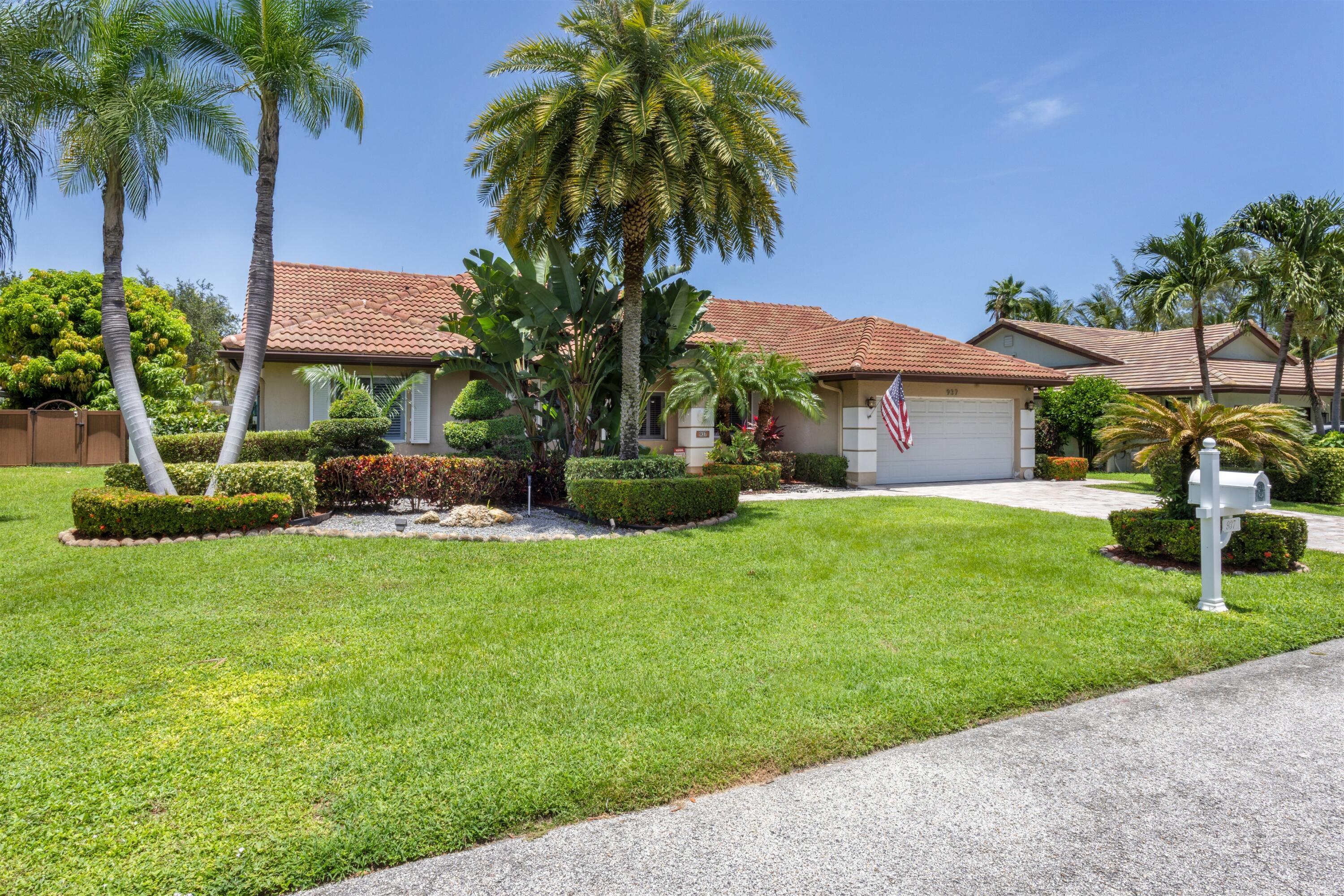 Image 2: single-story with barrel tile roof and lush landsc
