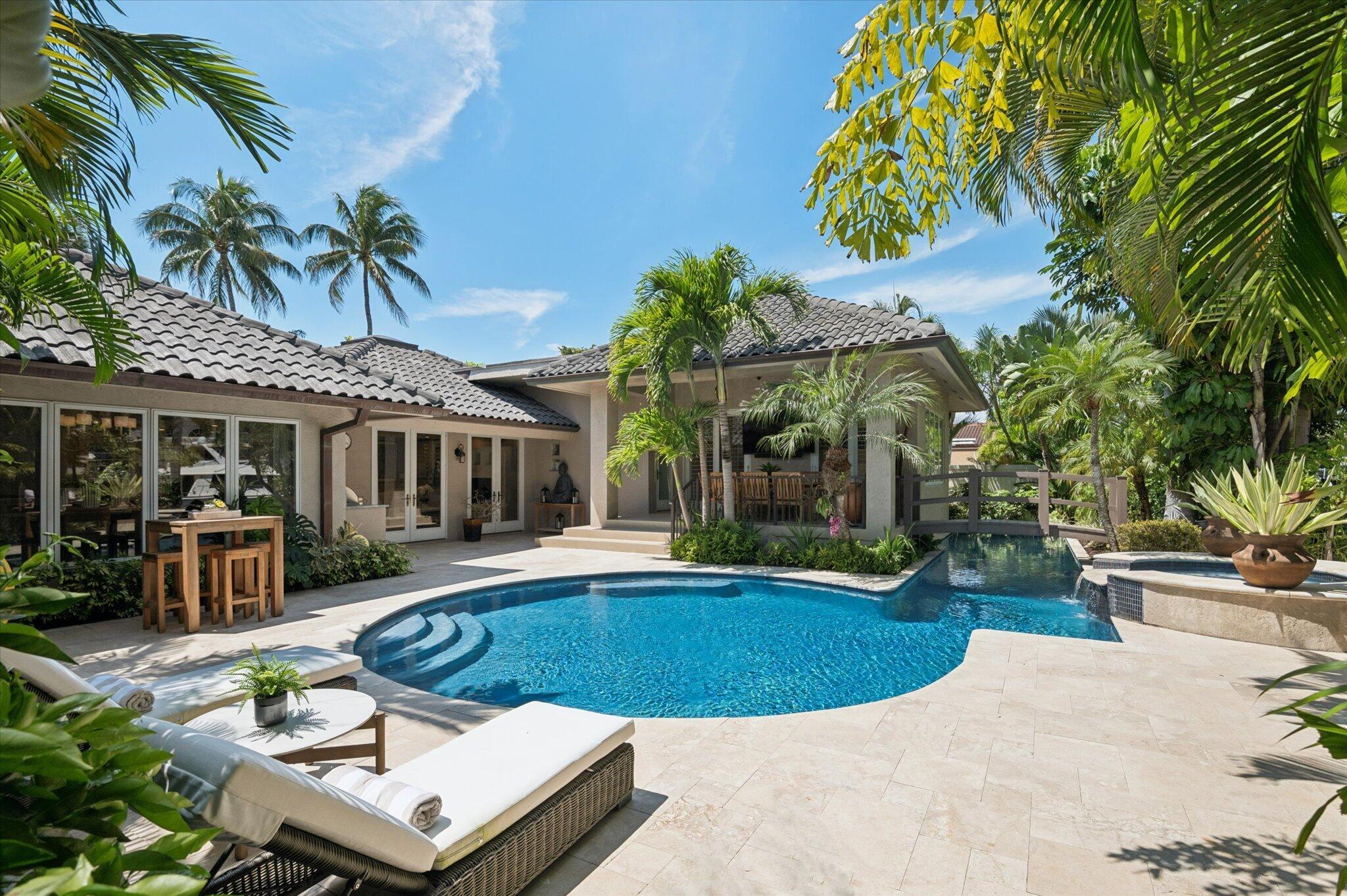 Image 1: This backyard oasis includes a summer kitchen, out