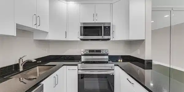 Image 2: Custom cabinets and stainless steel appliances