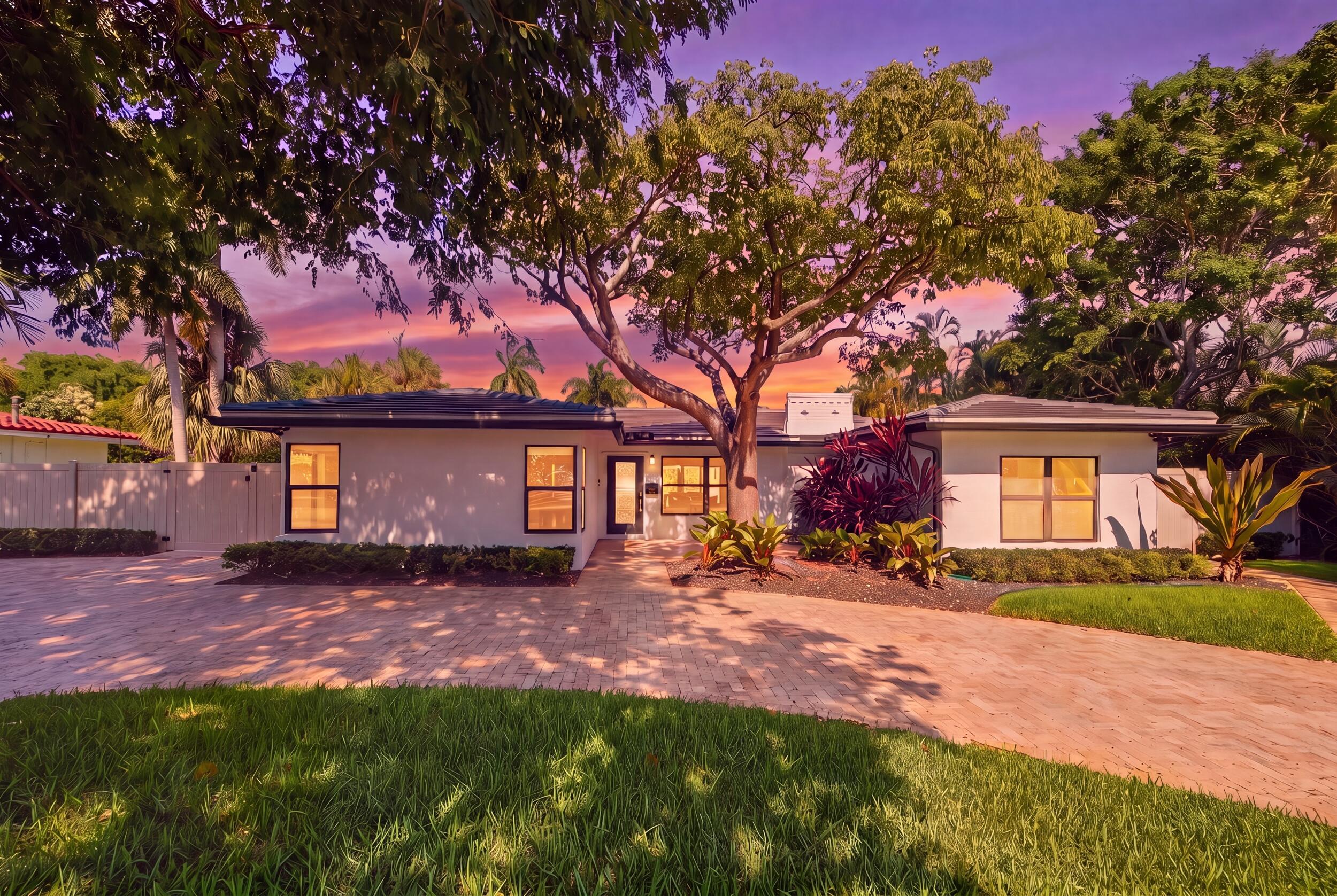 Image 3: Contemporary residence featuring a paved driveway,