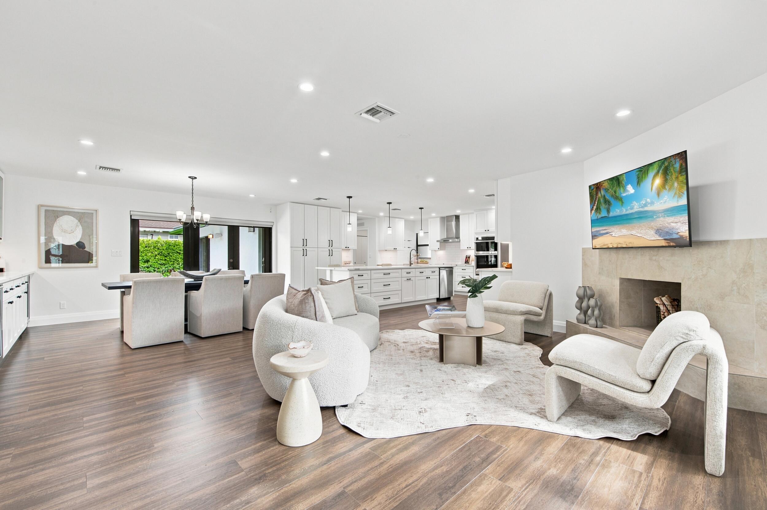 Image 4: Open-concept living area featuring wood-finish flo